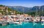 Den maleriske havn Port de Sóller på den nordvestlige kyst af Mallorca i Spanien, smukt omgivet af Tramuntana-bjergene.